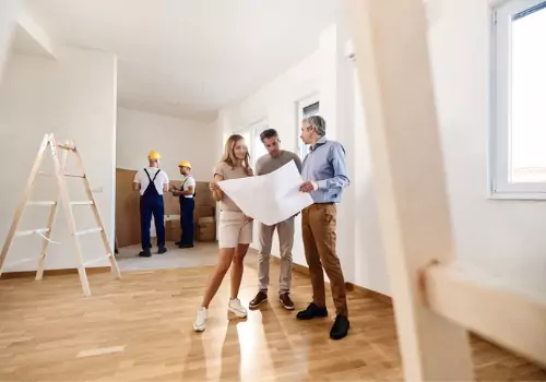 A couple reviews plans of their new home designed by Johnson's Building Company, which are Home Builders Near You in Bloomington IL